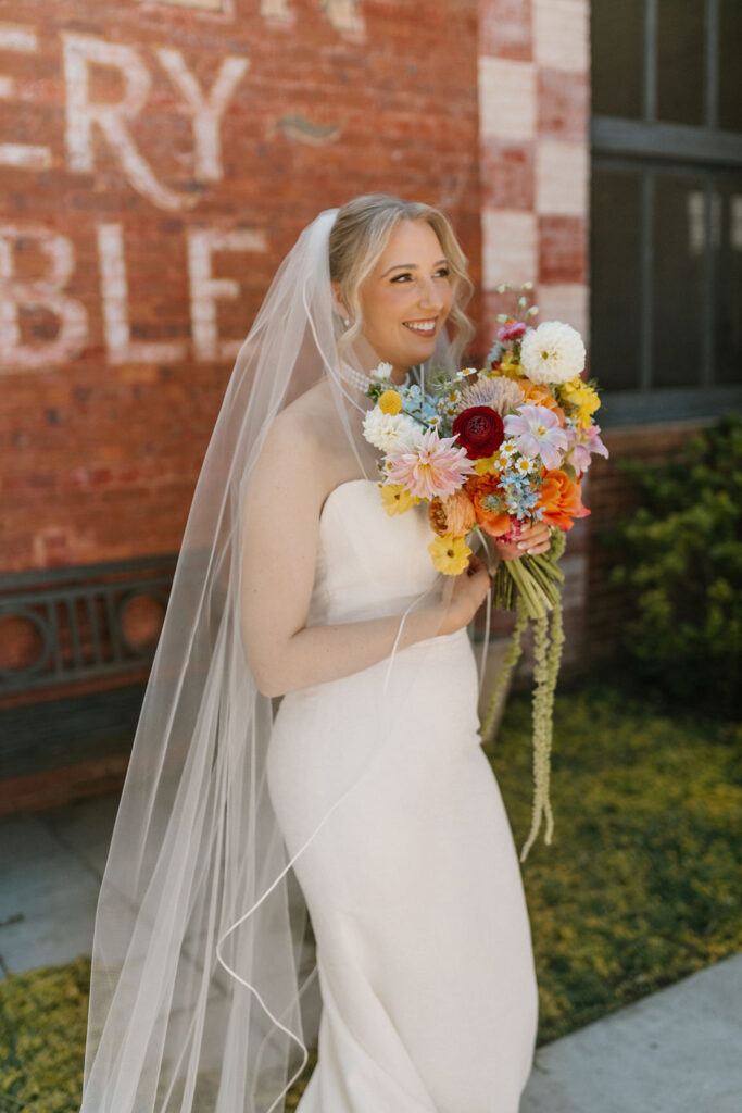 Bride holding vibrant wedding bouquet at Empire Mills in GA.